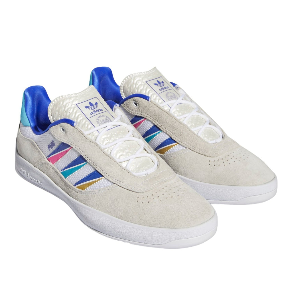 An ADIDAS PUIG CLOUD WHITE / SONIC INK / SIGNAL CYAN shoe with multi colored stripes.