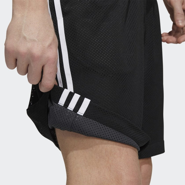 A man wearing black and white ADIDAS BBALL SHORT BLACK / WHITE shorts playing basketball.