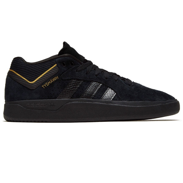 A black ADIDAS TYSHAWN BLACK / BLACK / GOLD shoe.