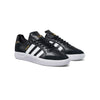 A BLACK ADIDAS TYSHAWN LOW BLACK / WHITE sneakers with gold accents.