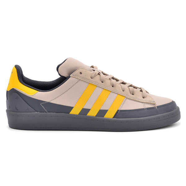 A white and yellow ADIDAS X POP TRADING CO. CAMPUS ADV sneakers on a white background.