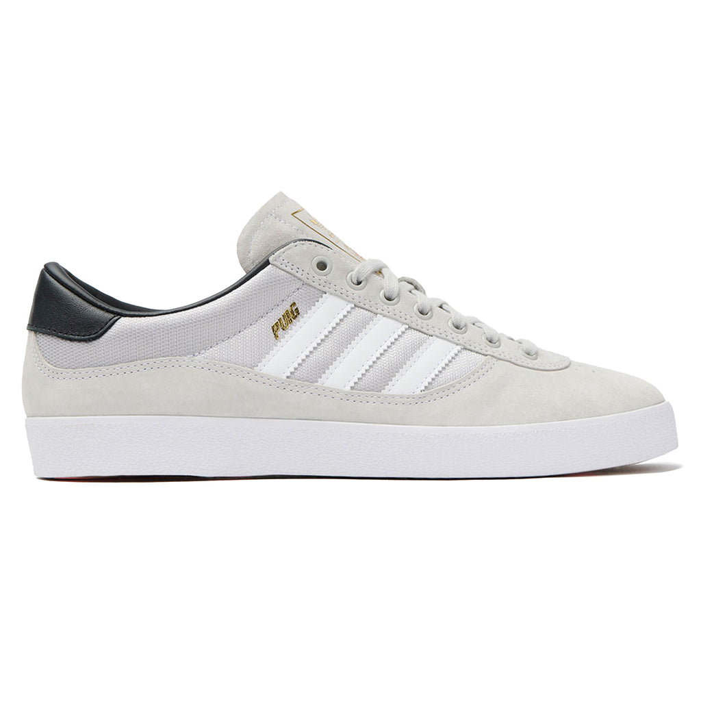 A white and black Adidas Puig Indoor White/Grey sneakers on a white background.