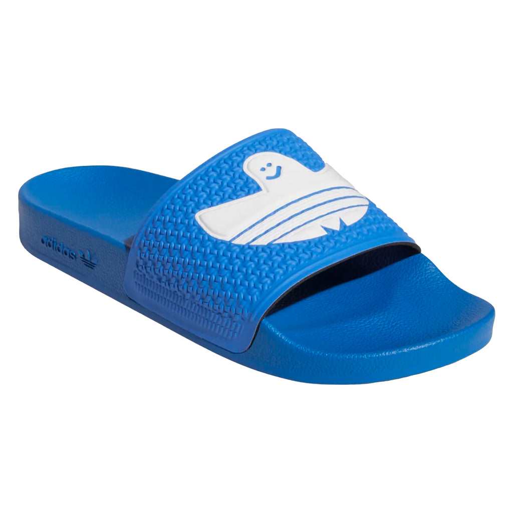 A pair of ADIDAS SHMOOFOIL BLUE BIRD / WHITE slippers with a white shark on it.