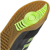 A close up of the sole of an adidas Copa Nationale Black / Signal Green / Gum soccer shoe.