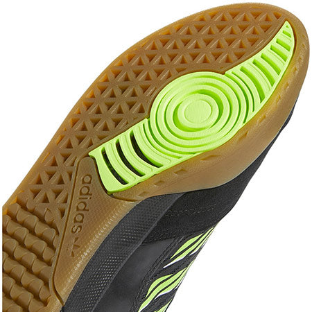 A close up of the sole of an adidas Copa Nationale Black / Signal Green / Gum soccer shoe.