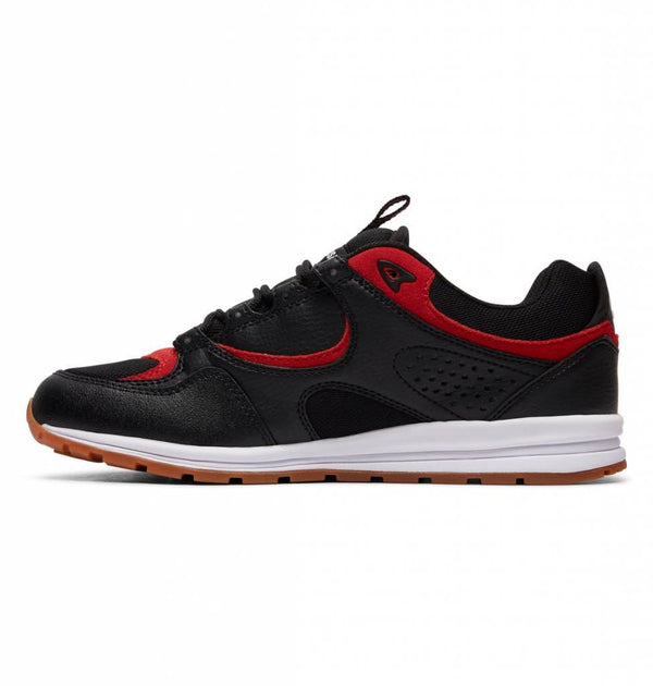 The DC Kalis Lite Shoes, co-designed by skateboarding legend Josh Kalis, is a sleek skate shoe that features a black and red color scheme with vibrant red accents.