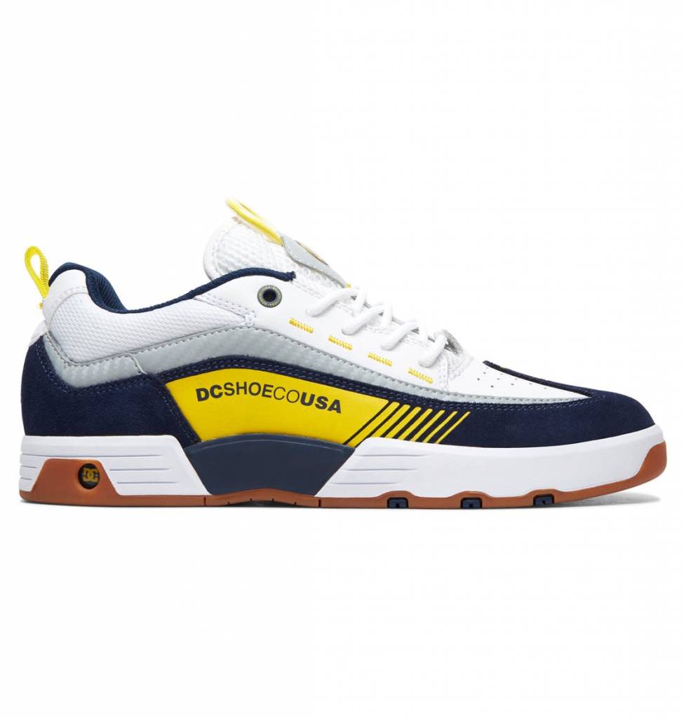 A pair of DC Shoes Legacy 98 Slim White / Yellow / Navy skate shoes featuring a suede footbed.