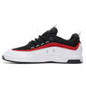 A DC Legacy 98 Slim black and red leather skate shoe with white and red accents known for its durability.