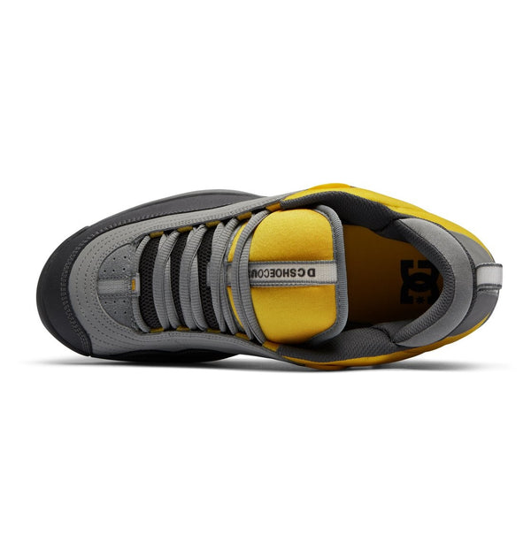 A pair of yellow and grey DC Williams OG skate shoes on a white background.