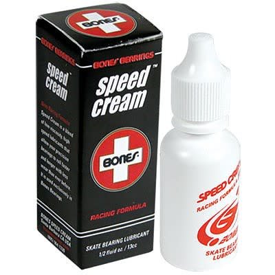 A bottle of white Speed Cream next to the black box packaging.