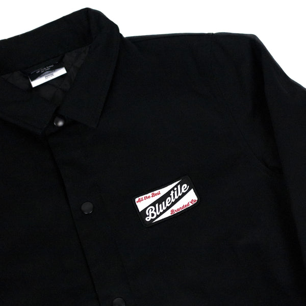 A Bluetile Skateboards black shirt with a logo on it.