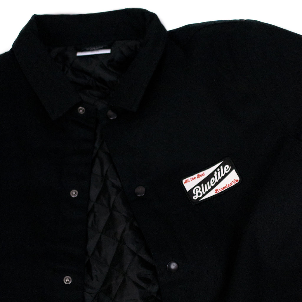 A BLUETILE CRAFT MECHANIC JACKET BLACK with a patch on it by Bluetile Skateboards.