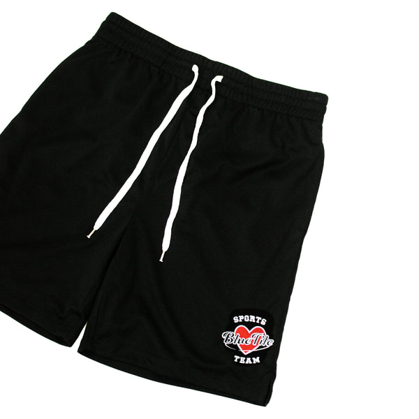 A Bluetile Skateboards black short with a red heart on it, perfect for sports enthusiasts.