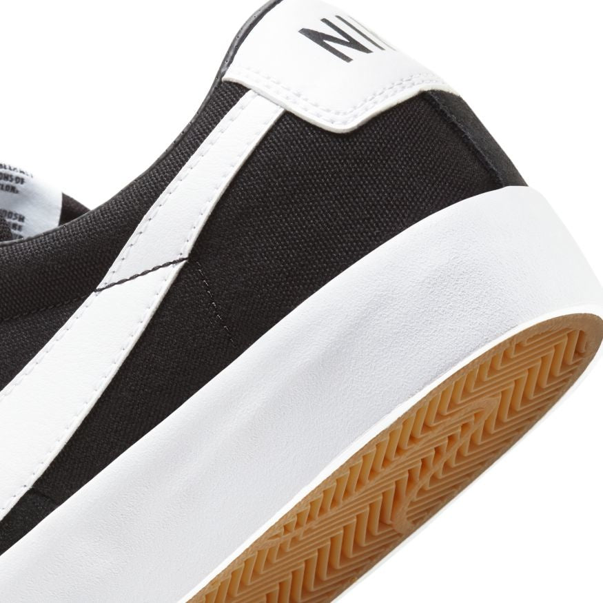 A black and white Nike SB Blazer Low Pro GT tennis shoe with a rubber sole.