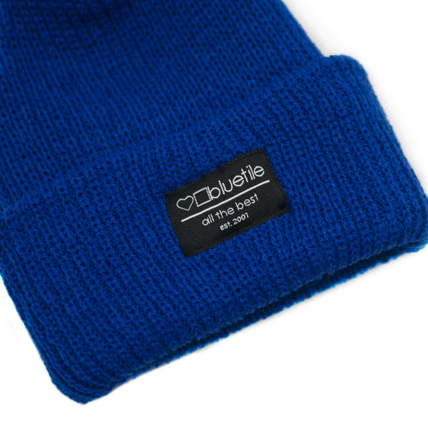 A Bluetile Skateboards BLUETILE SURPLUS KNIT BEANIE ROYAL BLUE with a label on it.