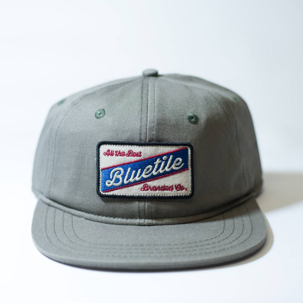 Product Description: This BLUETILE "ALL THE BEST" COLOR PATCH FATIGUE GREEN hat by Bluetile Skateboards features a stylish blue and white patch, adding a touch of uniqueness to your ensemble. Perfect for fans of the Last Jedi, this hat is designed to elevate your fashion game.