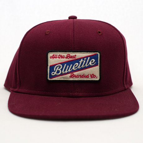 A BLUETILE "ALL THE BEST" PATCH SNAPBACK hat with a patch on it. (Brand Name: Bluetile Skateboards)