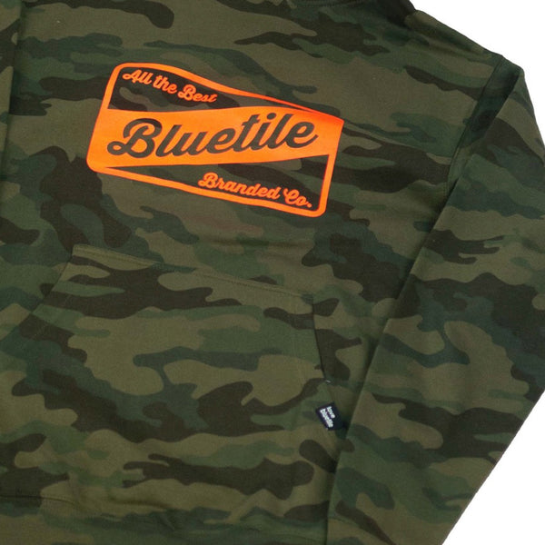 This BLUETILE CRAFT HOODIE CAMO GLO/ORG features the word "Bluetile Skateboards" prominently displayed on it.