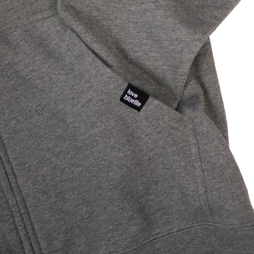 The back of a BLUETILE CRAFT ZIP HOODIE GREY with a black logo on it.