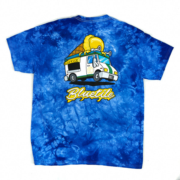 A Bluetile Skateboards blue tiedye t-shirt with a yellow truck on it. Bluetile Munchies Delivery Back Print.