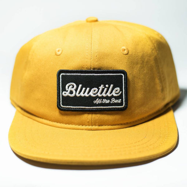 A BLUETILE "ALL THE BEST" PATCH MUSTARD YELLOW hat from Bluetile Skateboards with a new hat color on it.
