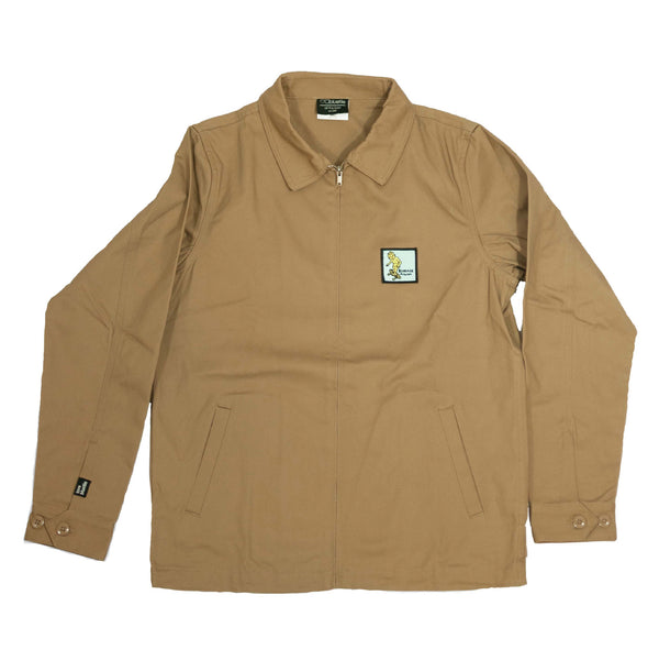 A BLUETILE X GONZ UNION JACKET KHAKI with a yellow patch on it.