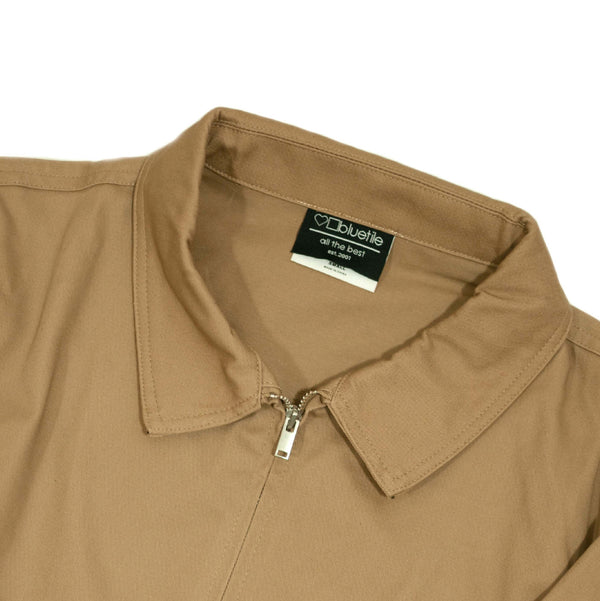 A tan BLUETILE X GONZ UNION JACKET KHAKI with a zipper on the front.