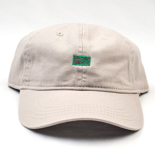 A BLUETILE LOVEBOXES DAD HAT by Bluetile Skateboards with a green patch on it.