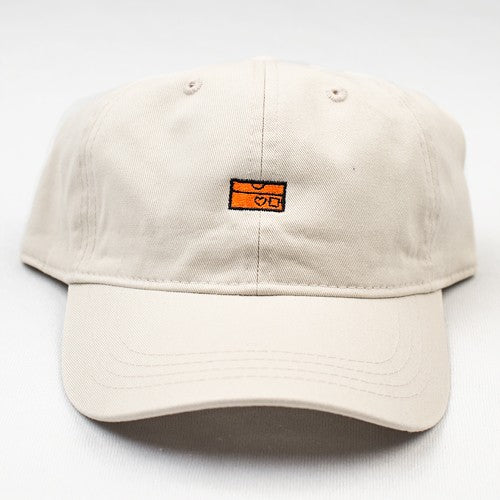 A BLUETILE LOVEBOXES DAD HAT ORANGE / CREAM with an orange patch on it.