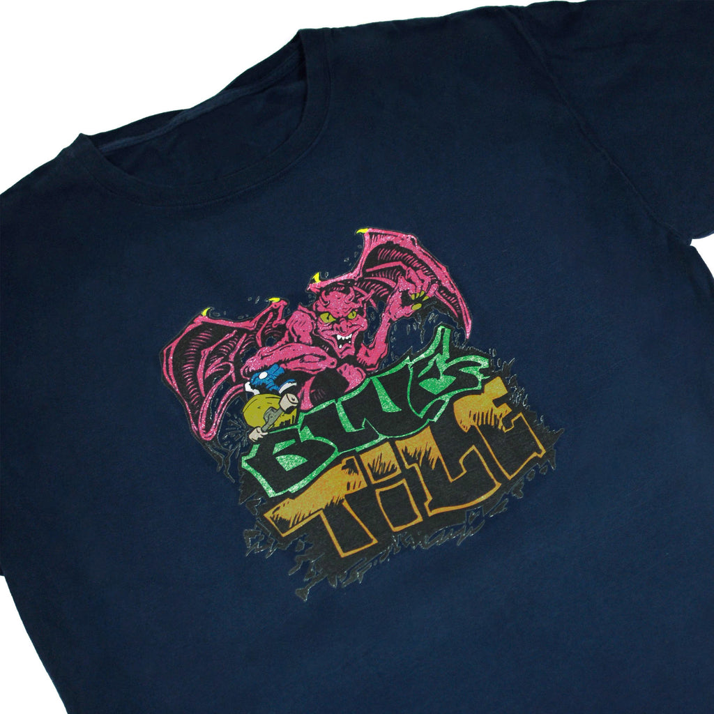 A Bluetile Skateboards BLUETILE SKATE PIT TRIBUTE T-SHIRT NAVY with an image of a demon on it.