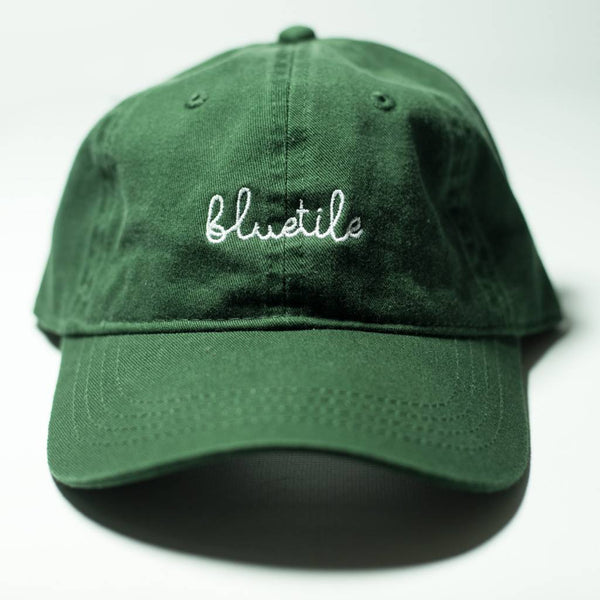 A BLUETILE SCRIPT DAD HAT GREEN with the word 'bliss' embroidered on it.