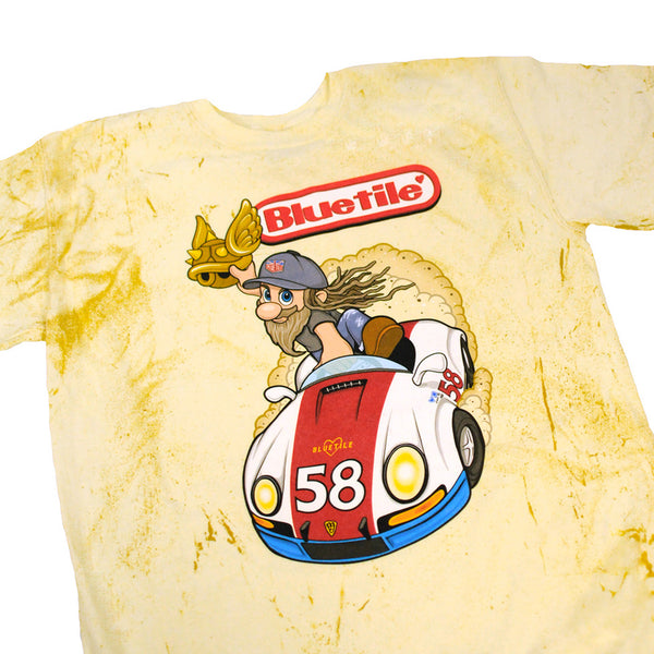 A yellow BLUETILE STREET RACER T-SHIRT GOLD PATINA with an image of a dog riding a car. (Brand: Bluetile Skateboards)