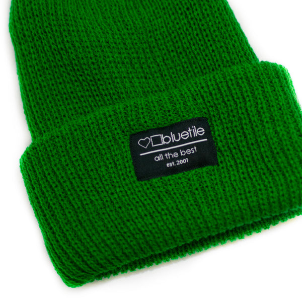 A BLUETILE SURPLUS KNIT BEANIE KELLY GREEN with a Bluetile Skateboards Label on it.
