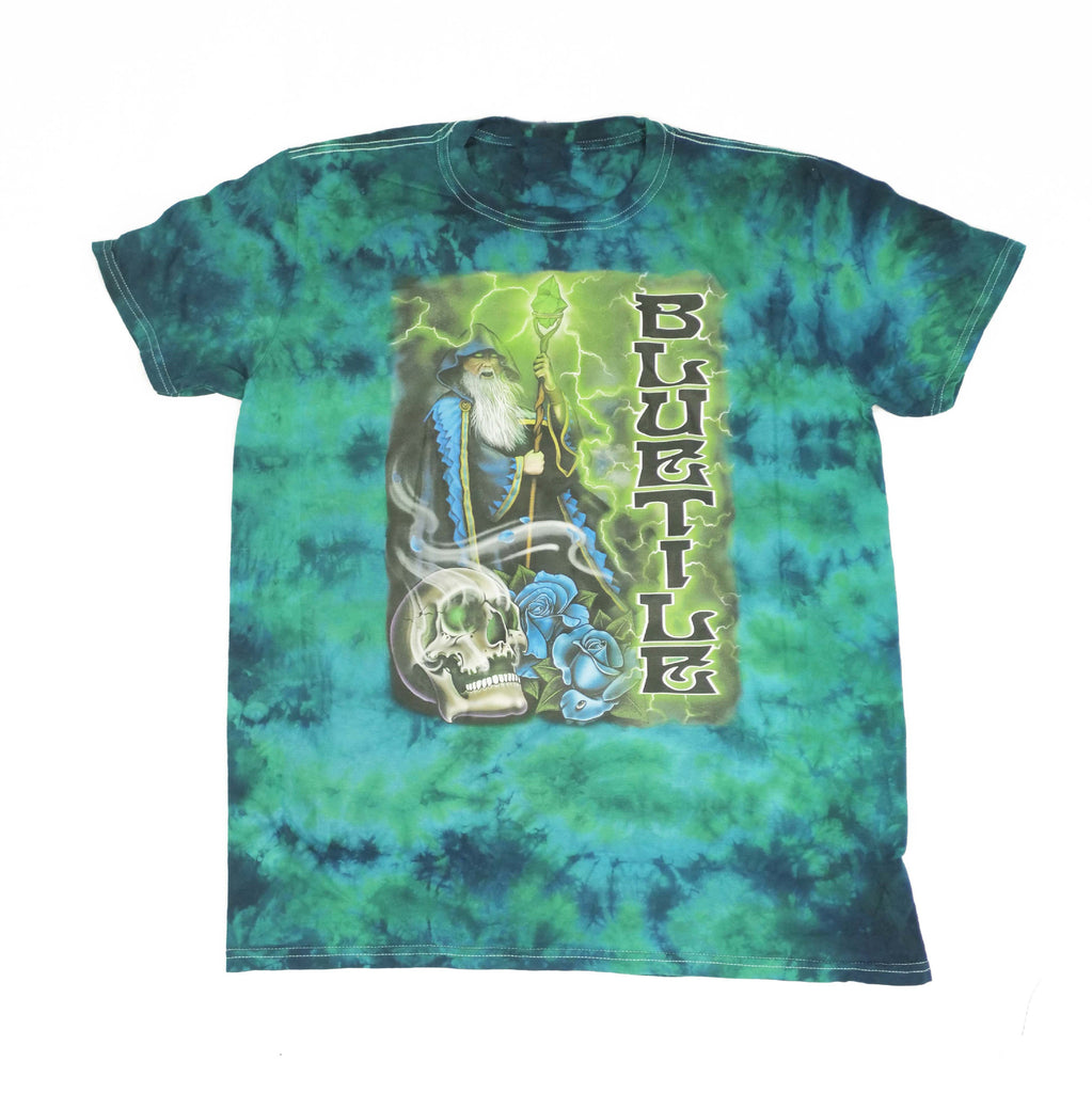 A Bluetile Skateboards BLUETILE TRIPPY WIZARD T-SHIRT GREEN BURST with an image of a skeleton.