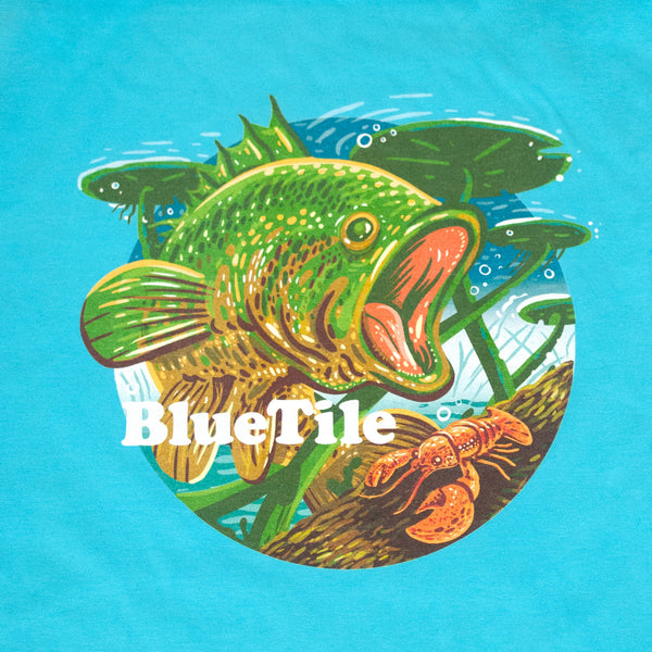 A Bluetile Skateboards BLUETILE WILDERNESS BASS T-SHIRT FRESHWATER BLUE with a fish on it.