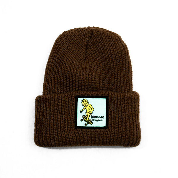 A BLUETILE X GONZ SKETCHY PATCH BEANIE BROWN with a yellow patch on it. (Brand: Bluetile Skateboards)