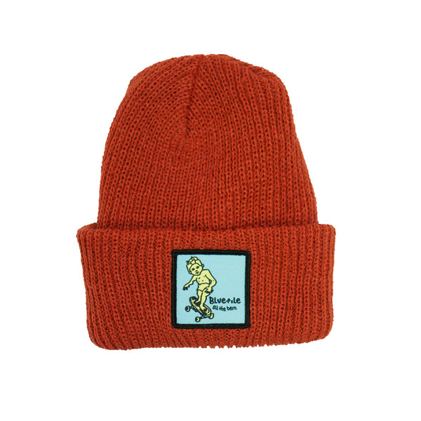 A BLUETILE X GONZ SKETCHY PATCH BEANIE ORANGE by Bluetile Skateboards with a BLUE patch on it.