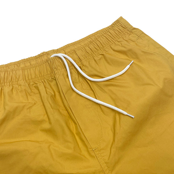 A pair of BLUETILE SURPLUS BEACH SHORT MUSTARD on a white background.