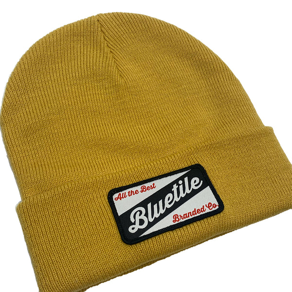 A yellow BLUETILE CRAFT PATCH BEANIE MUSTARD with a bluele patch.
