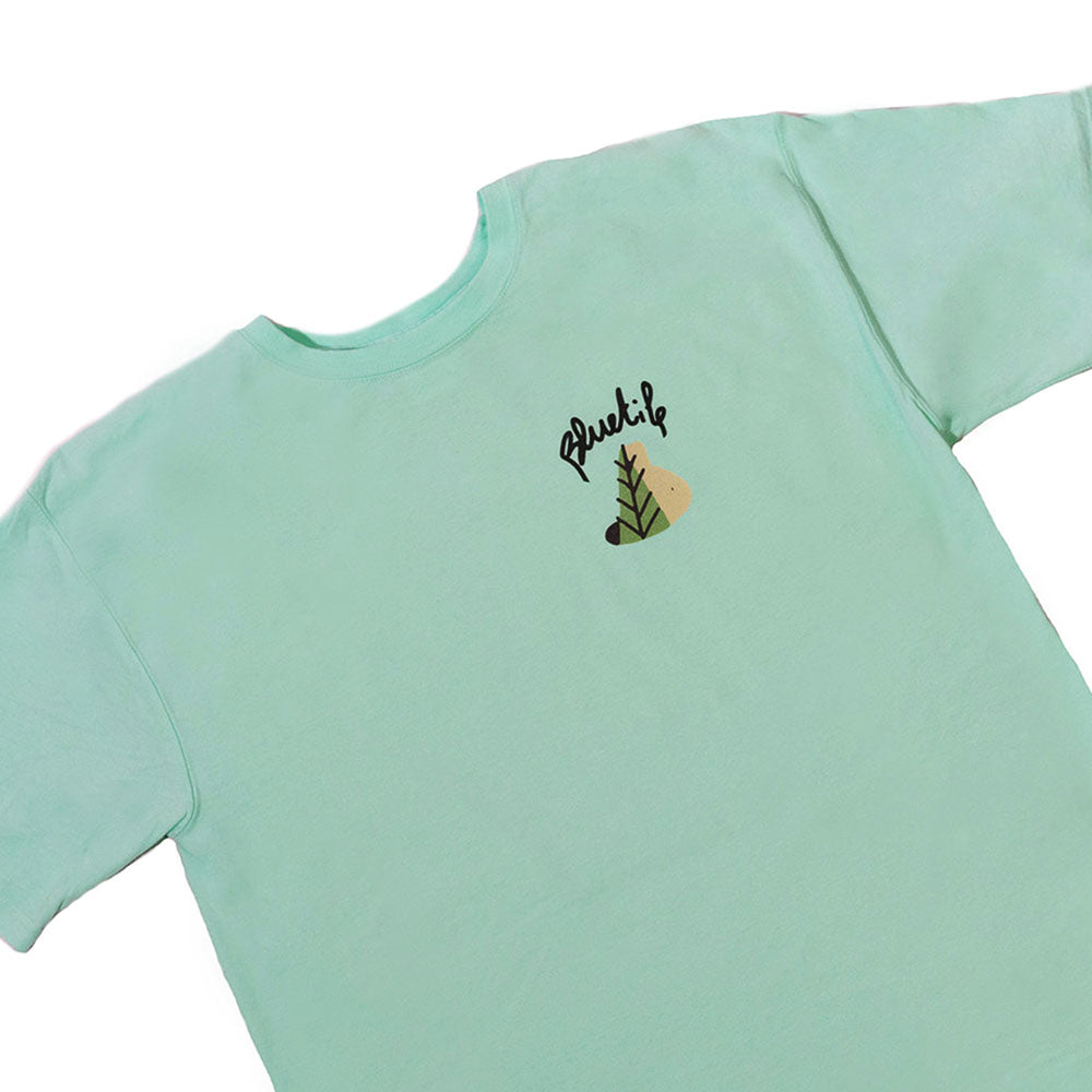 A BLUETILE X L.B. MAGICAL QUEST TEE TEAL with a bear embroidered on it (from the brand Bluetile Skateboards).