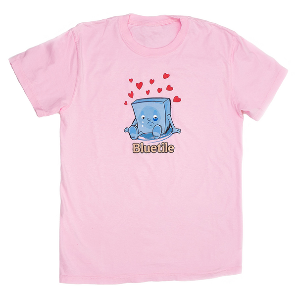 A Bluetile Skateboards pink t-shirt with an image of a cube with hearts on it.