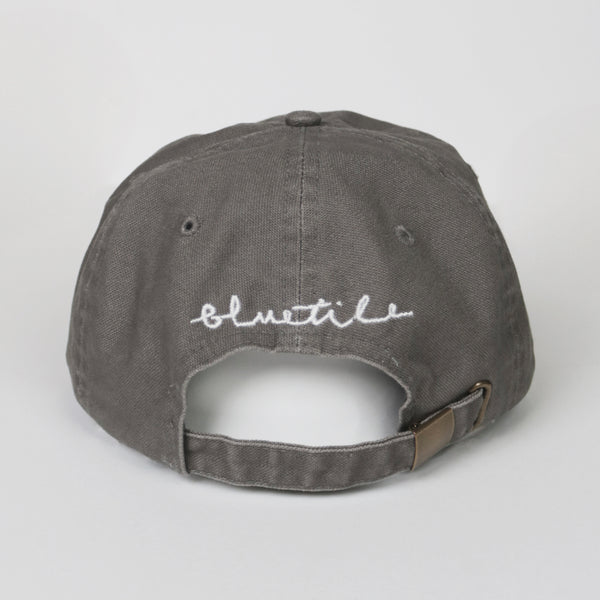 A Bluetile Skateboards gray hat with a white inscription on it.