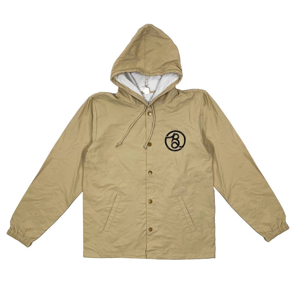 A Bluetile Skateboards jacket with a hood and a logo on it, specifically the BLUETILE SUPLY CO. COACHES JACKET BONE.