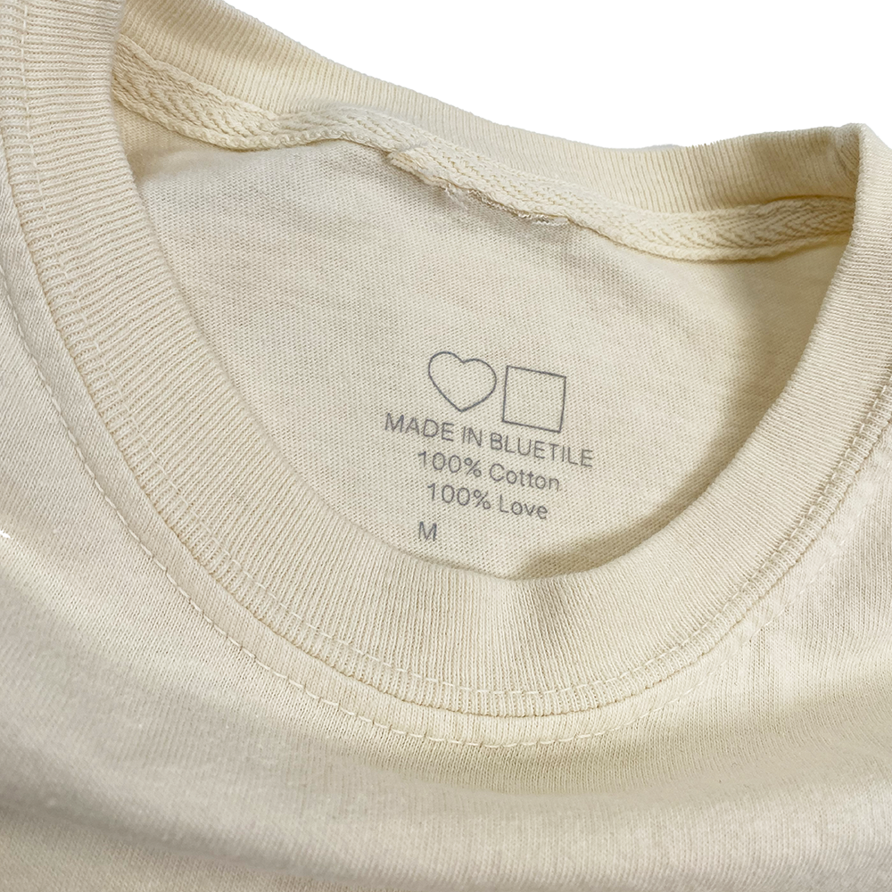 A close up of a BLUETILE BLUE TOMORROW SHIRT PARCHMENT with a heart on it, by Bluetile Skateboards.