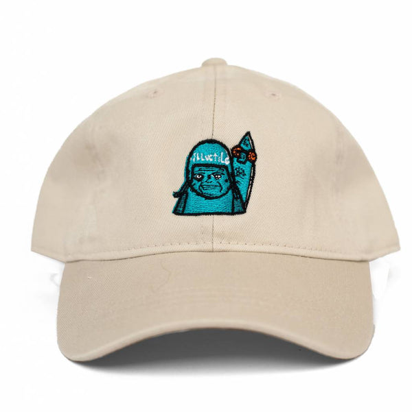 A BLUETILE "SKATE GRUMP" DAD HAT EGGSHELL with an image of a blue teddy bear on it.