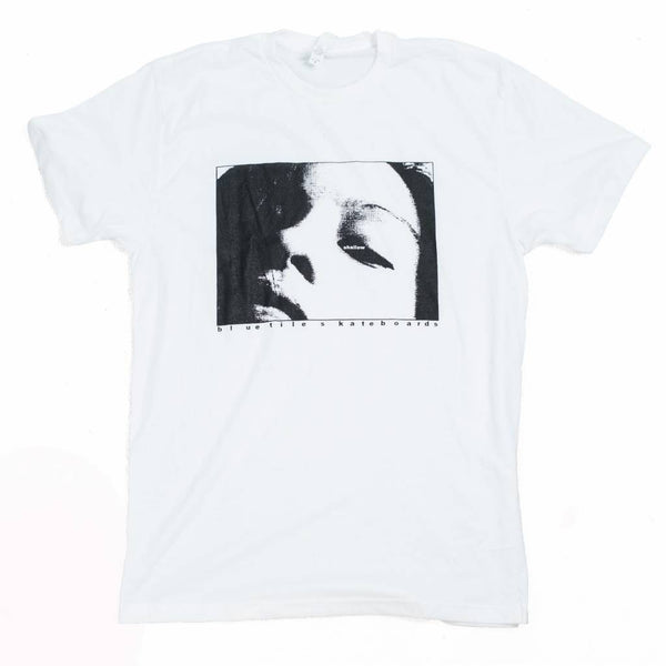 A BLUETILE X H. A. THOMAS "SHALLOW" WHITE t-shirt with a design of a woman's face. (Brand: Bluetile Skateboards)