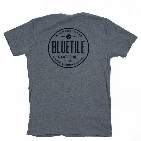 A BLUETILE 100% SKATEBOARDING GRAY/BLUE shirt with the word Bluetile Skateboards on it.