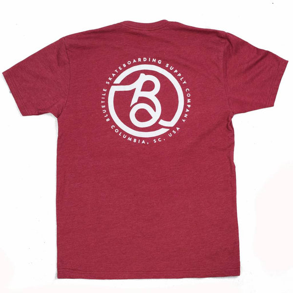 The back of a BLUETILE SUPPLY CO - RED / WHITE t-shirt with a white logo, printed in house for quality shirts.