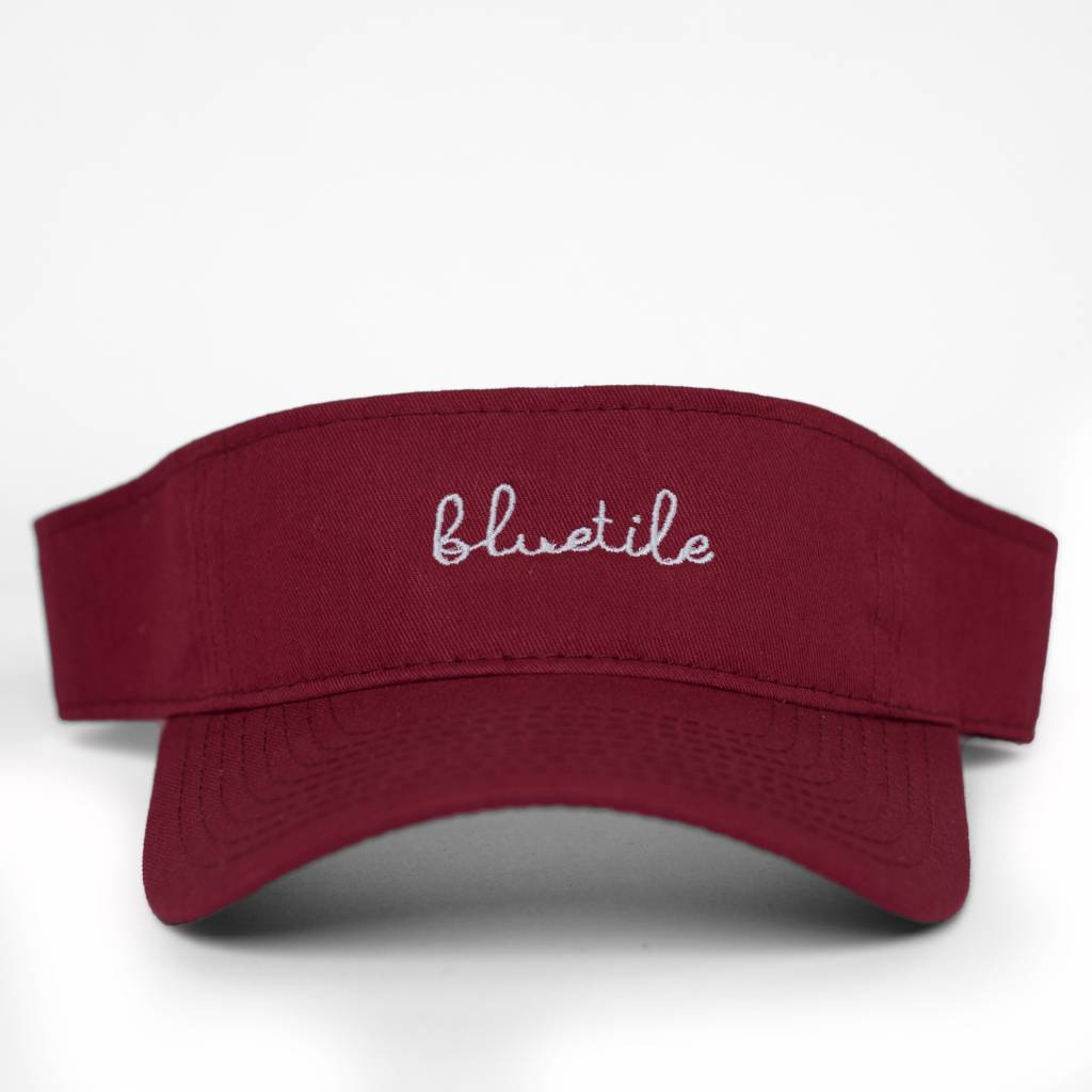 A clean and simple BLUETILE SCRIPT VISOR GARNETT with the word 'blush' embroidered on it by Bluetile Skateboards.