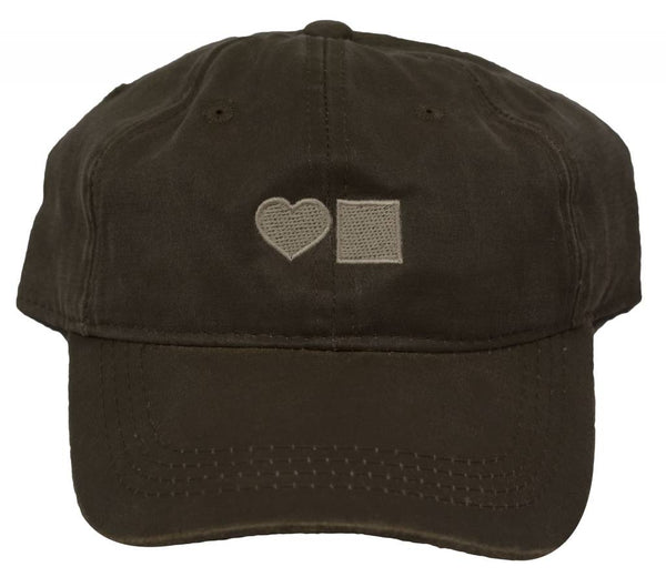A Bluetile Skateboards BLUETILE WAXED CANVAS DAD HAT OLIVE with a heart on it.